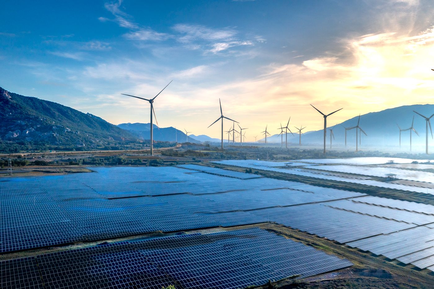 Solar panels and wind turbines producing renewable energy